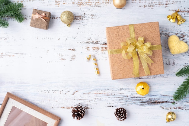 Christmas Gift boxes with gold ribbon and Decorations on white wooden board.