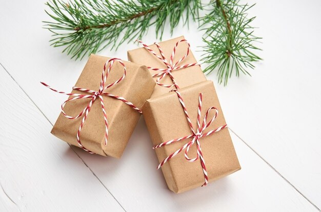 Christmas gift boxes with pine tree branch on white