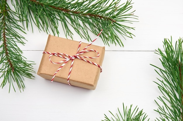 Christmas gift boxes with pine tree branches on white