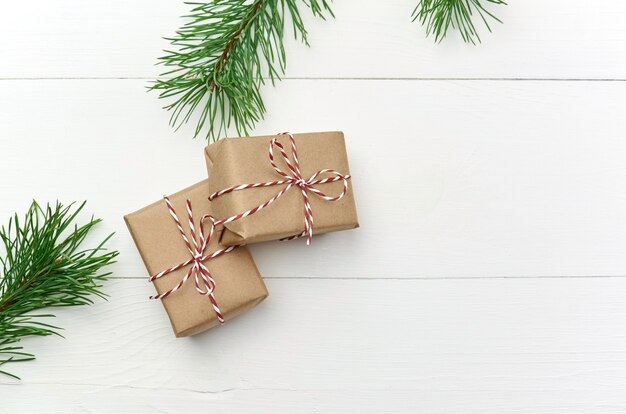 Christmas gift boxes with pine tree branches on white