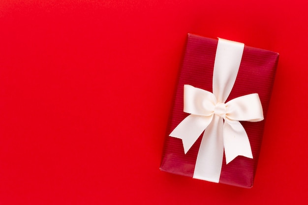 Christmas gift boxes with ribbons on color tabletop.