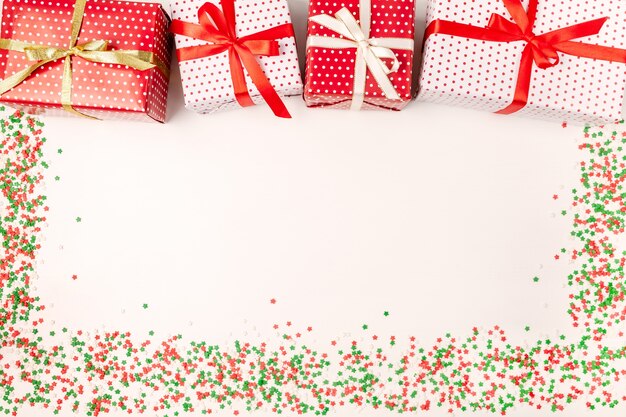 Christmas gift boxes with ribbons and sparkles on white 