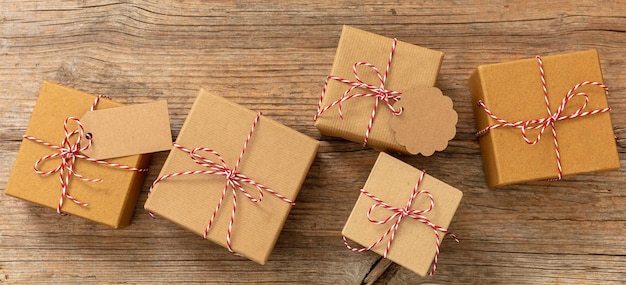 Christmas gift boxes on wooden background red white twisted\
string on brown parcels