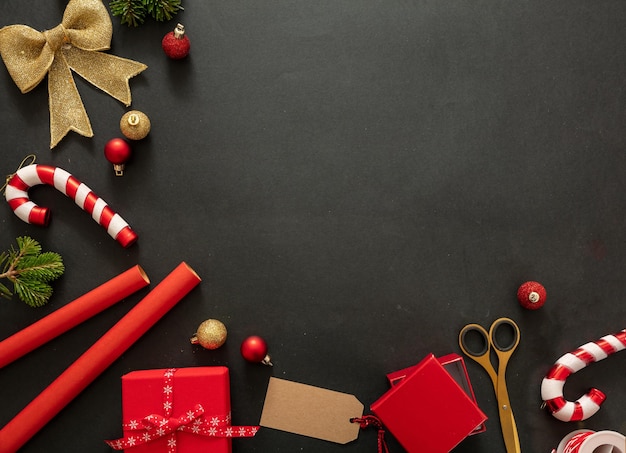 Christmas gift boxes wrapping on black background top view