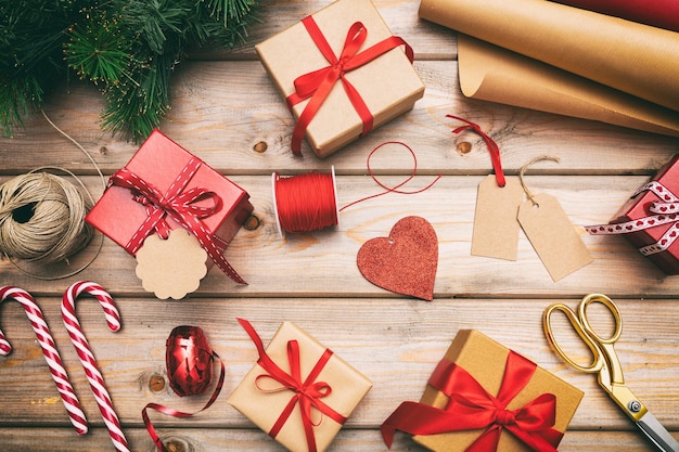 Christmas gift boxes wrapping on wooden background top view