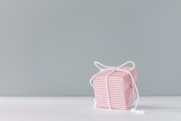 Christmas gift Festive pink box on gray background