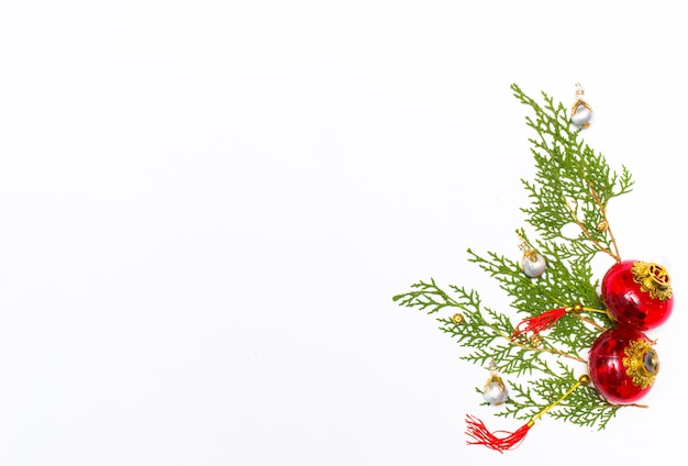 Christmas gift, knitted blanket, pine cones, fir branches on wooden white background. Flat lay, top view