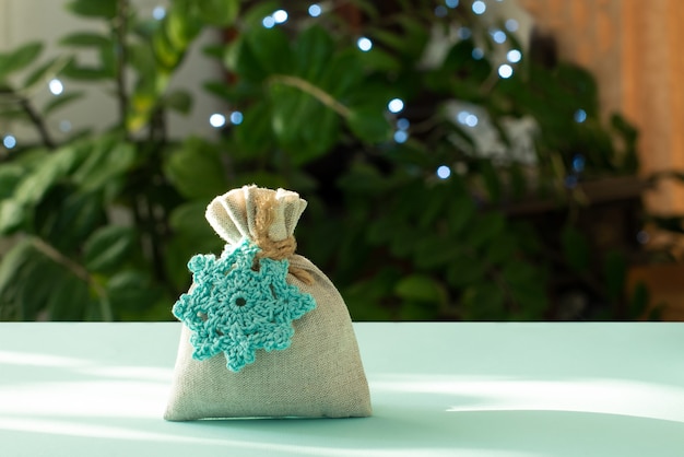 Christmas gift. Packaging in eco-friendly materials, furoshiki fabric. Bokeh, selective focus