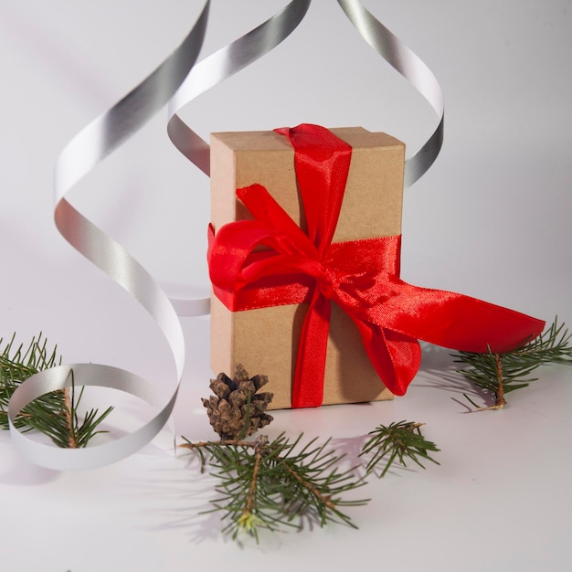 Christmas gift in paper box with red ribbon