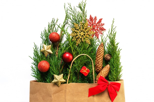 Christmas gift paper package wrapping with pine spruce pine branches and Christmas 