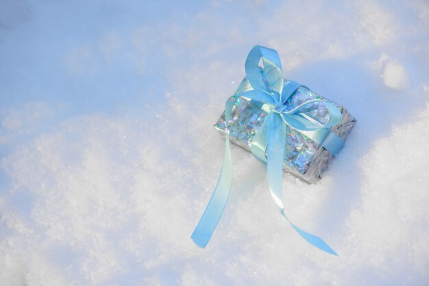 Christmas gift pink with bow box on blue background.