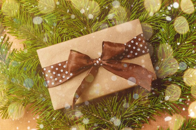 Christmas gift or present box wrapped in kraft paper on christmas decoration