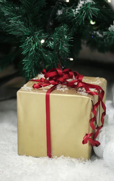 Christmas gift on white snow, ornamental studio shot