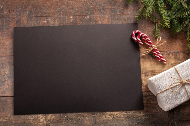 Christmas gift with black paper on a wooden table