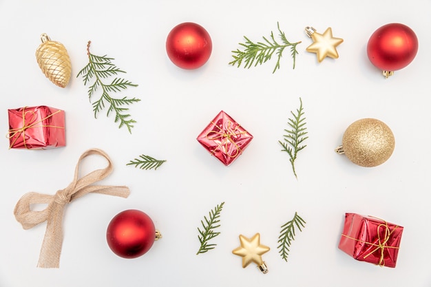 Christmas gift with gold and red balls bow isolated on white background