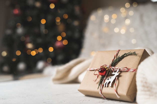 Christmas gift with juniper and Glowing snow bokeh.