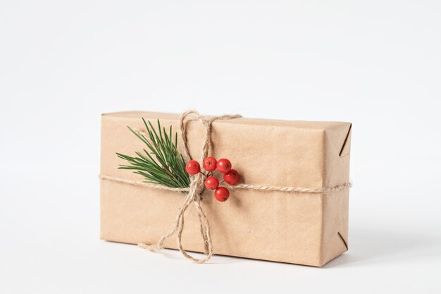 Christmas gift wrapping. Spruce branches, white background.