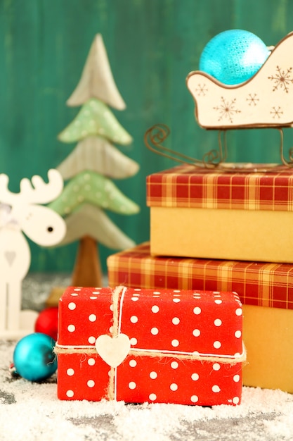 Christmas gifts on color wooden background