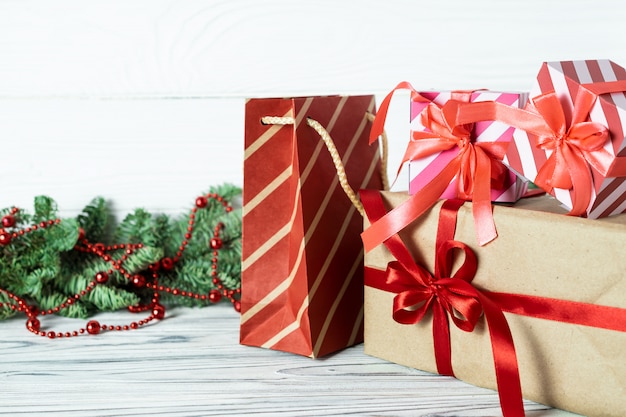 Christmas gifts, decorations and fir branches on a wooden .