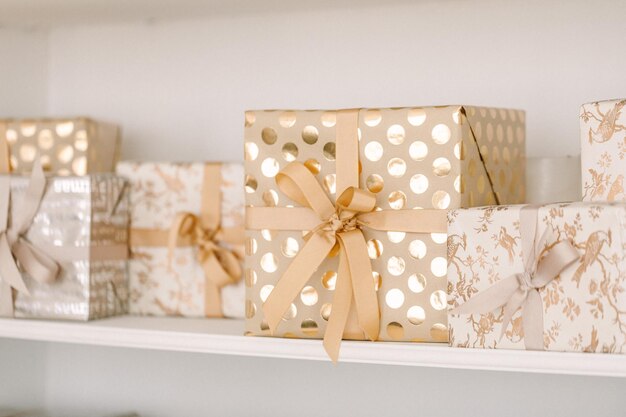 Christmas gifts in golden and silver wrapping and boxes with golden ribbons. Christmas decorations