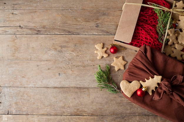 Christmas gifts packed furoshiki lie on a brown wooden table