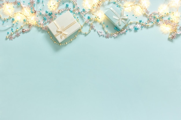 Christmas gifts, shiny, glossy beads decorations on turquoise background.