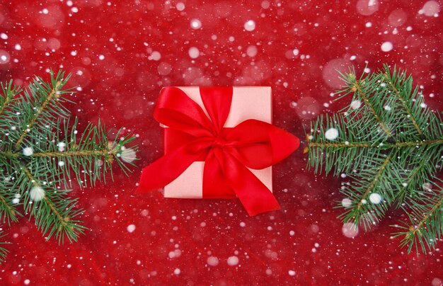 Christmas gifts with red ribbon on red background with decorations