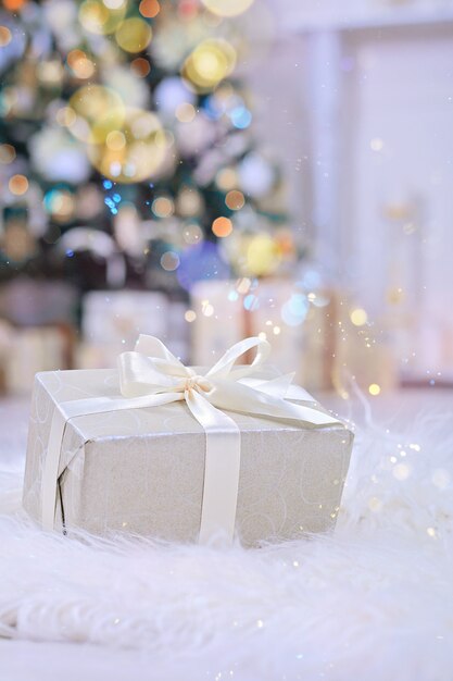 Photo christmas gifts with white ribbon under christmas tree.