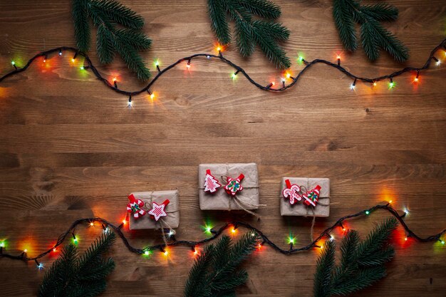 Christmas gifts on wooden background in vintage style