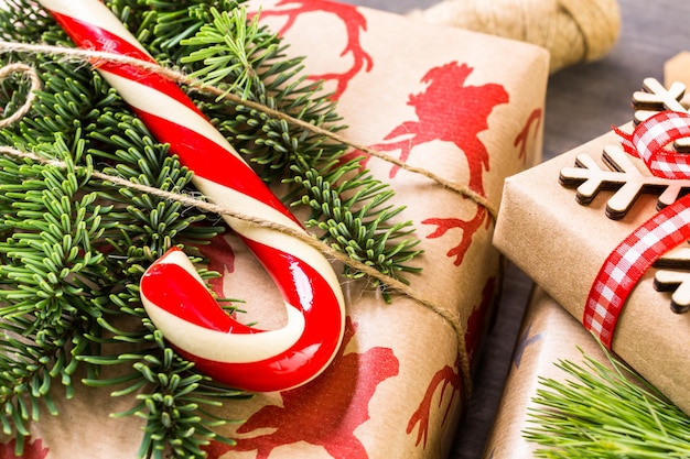 Christmas gifts wrapped in brown paper with red ribbons.