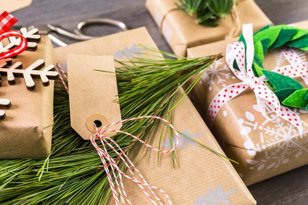 Christmas gifts wrapped in brown paper with red ribbons.