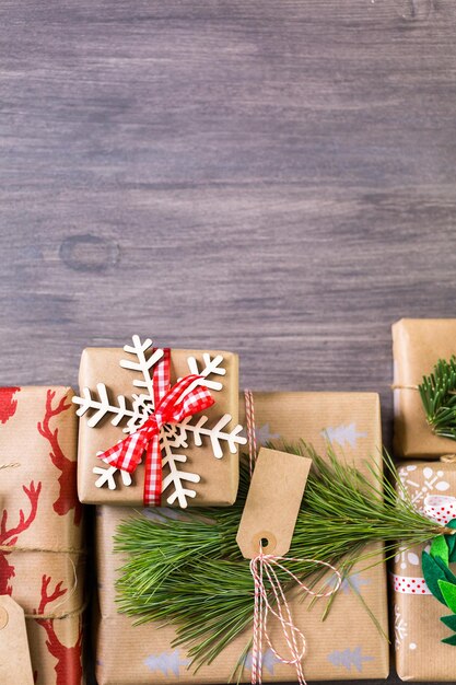 Christmas gifts wrapped in brown paper with red ribbons.