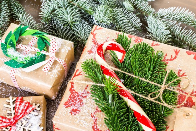 Christmas gifts wrapped in brown paper with red ribbons.