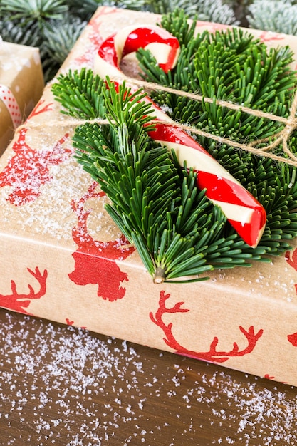 Christmas gifts wrapped in brown paper with red ribbons.