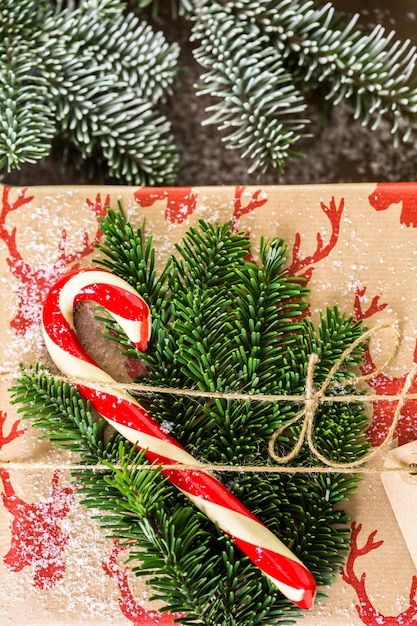 Christmas gifts wrapped in brown paper with red ribbons.