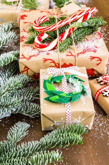 Christmas gifts wrapped in brown paper with red ribbons.