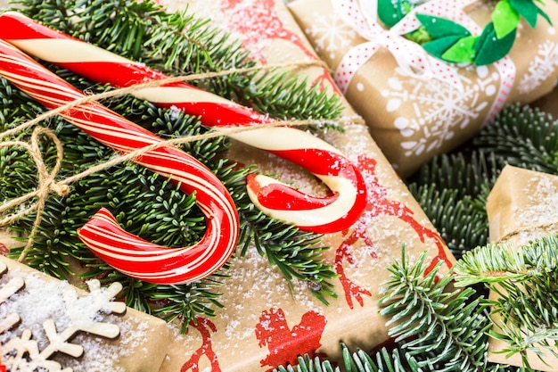 Christmas gifts wrapped in brown paper with red ribbons.