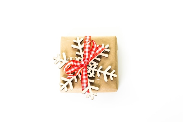 Christmas gifts wrapped in brown paper with red ribbons.