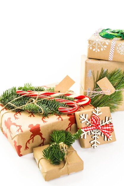 Christmas gifts wrapped in brown paper with red ribbons.