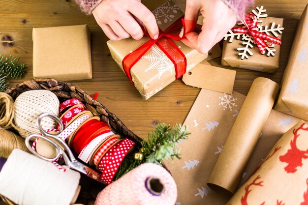 Christmas gifts wrapped in brown paper with red ribbons.