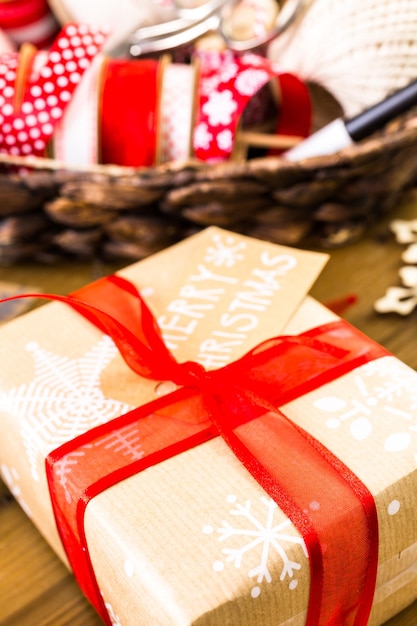 Christmas gifts wrapped in brown paper with red ribbons.