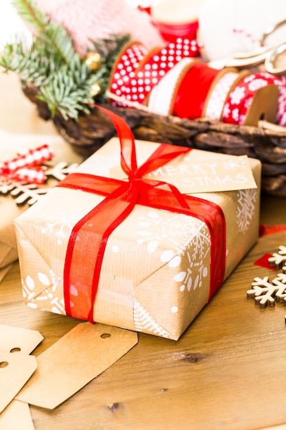 Christmas gifts wrapped in brown paper with red ribbons.