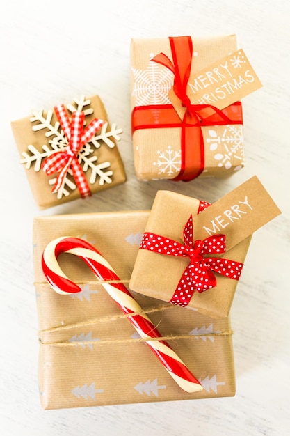 Christmas gifts wrapped in brown paper with red ribbons.