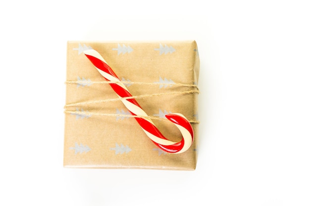 Christmas gifts wrapped in brown paper with red ribbons.