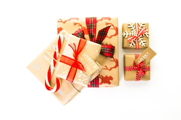 Christmas gifts wrapped in brown paper with red ribbons.