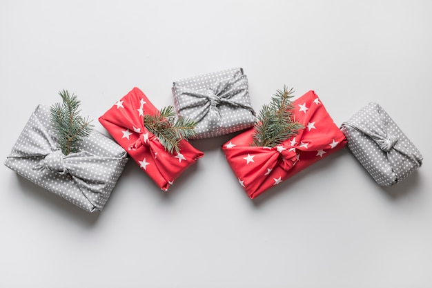 Christmas gifts wrapped in textile with natural decor.