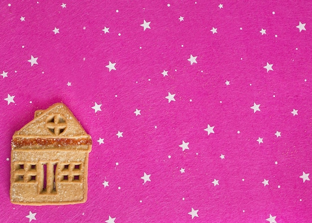 Christmas ginger cookies lying on a pink background