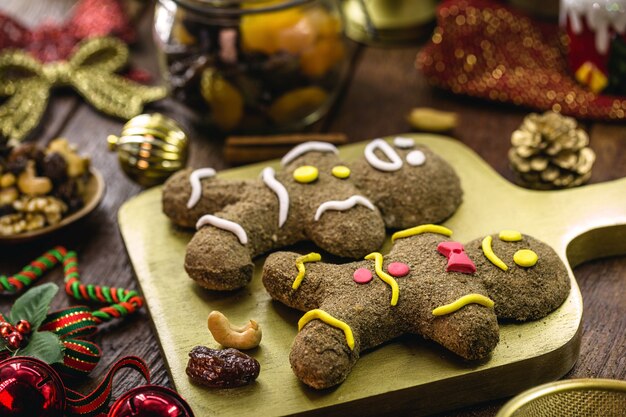 Biscotti di pan di zenzero di natale, omino di pan di zenzero fatto in casa, cotto al forno, con frutta e noci intorno