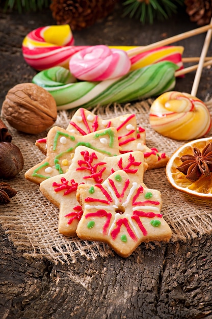 Christmas gingerbread cookies and lollipops  on old wooden background