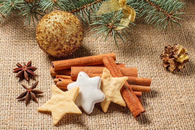 Christmas gingerbread cookies on sackcloth with cinnamon and star anise